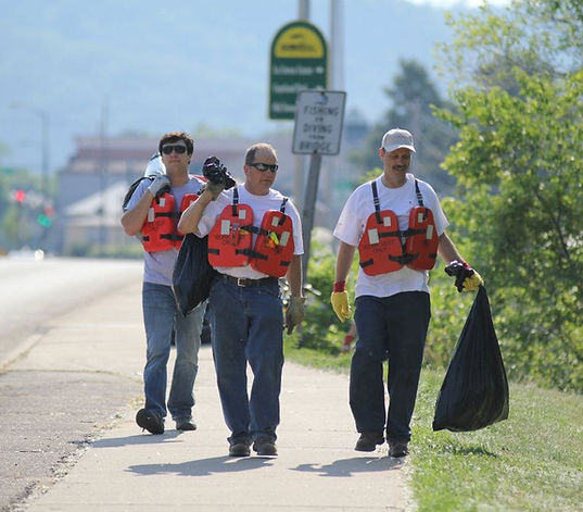 group-of-men-carrying-trash-bags