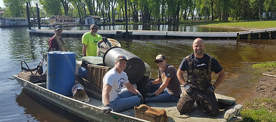 river-cleanup-group-bringing-in-trash-from-river-on-a-boat